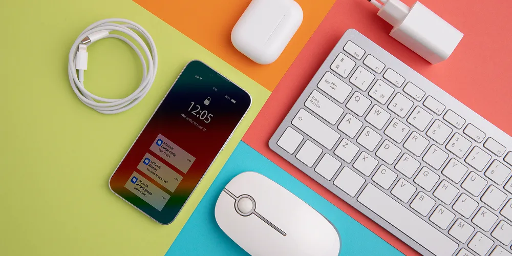 Modern workspace setup featuring smartphone keyboard charger mouse essentials daily